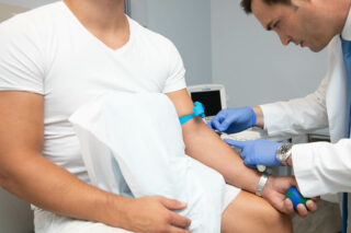 A doctor getting a blood sample from a patient